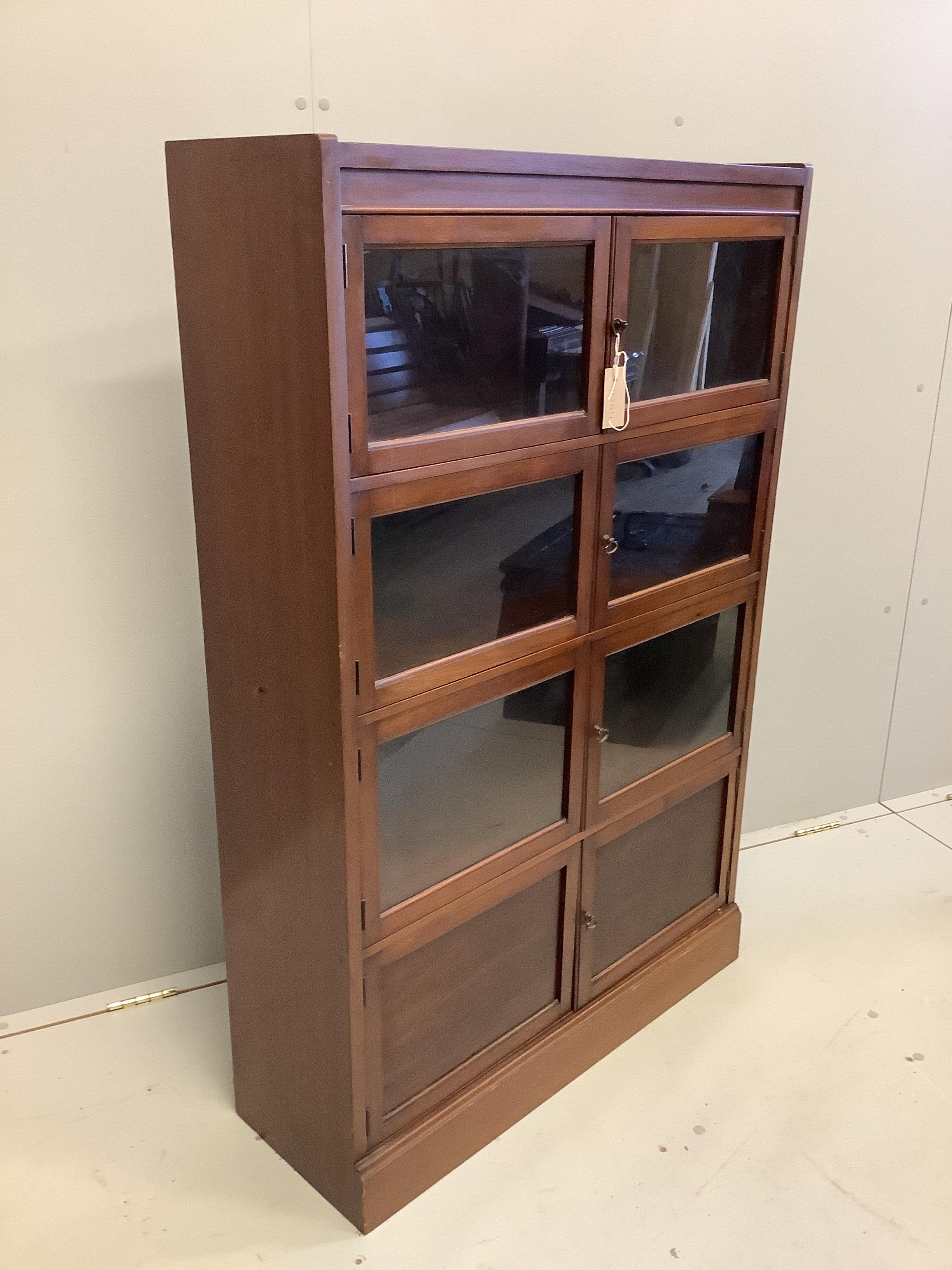 An early 20th century glazed mahogany bookcase, width 81cm, depth 27cm, height 126cm